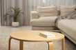 © New Africa - Book on wooden coffee table near sofa in living room