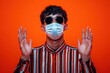 © sunny - Ill Student with Curly Hair Wearing a Mask Against Orange Background
