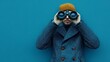 © Ceyhun - A sailor's peacoat with binoculars on a plain ocean blue background