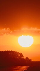 Wall Mural - Timelapse Big Sun Sundown Above Road. Bright Dramatic Sunset Sky Natural Background. Cars Drive On Road In Evening. Sunset Cloudy Sky With Fluffy Clouds. Sunset Time Lapse Time-lapse Timelapse In