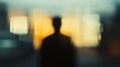 © musa - Blurred silhouette of a person against a bokeh city background.