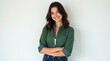 © Melissa - Smiling dark brown haired woman with crossed arm wearing green shirt on white background