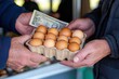 © Milos - A close-up of hands exchanging a carton of eggs for cash, depicting the essence of buying fresh, organic produce directly from a local farm or market.