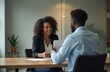 © miss irine - African young woman smiling during job interview handing over resume to manager. Recruitment process in company. HR specialist evaluates candidate. Successful career, employment, work opportunity,