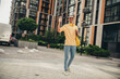 © deagreez - Young man in trendy casual outfit enjoying a walk through the urban city on a bright day