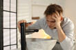 © New Africa - Unhappy young man suffering from hangover near sink in bathroom