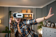 © Migma_Agency - Amazed mature woman wearing vr headset interacting with virtual reality at home