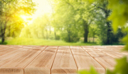 Wall Mural - empty wooden table top on green nature background. copy space for products.
