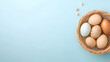 © WULANING - Easter eggs in a nest on a pastel blue background