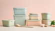© Sutarto Stock - Stack pastel-colored plastic storage containers wooden utensils eggs a beige surface.