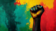 © Jack - Black History Month background. Black power hand fist over red yellow green black colors background