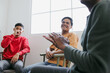 © Gatot - Portrait Of Smiling Young Asian Man Focused Looking His Friend On Therapy Session. Interactive Group On Therapy Session.