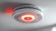 © Quantum - A ceiling-mounted smoke detector displaying a red light, indicating an alert status for fire safety.