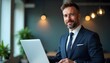 © Shams - The Confident Professional: A distinguished businessman, exudes confidence and approachability while using a laptop.