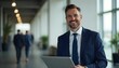 © Shams - The Confident Executive: A poised businessman exudes professionalism and success as he strides confidently through a contemporary office setting, clutching a tablet, and flashing a sincere smile.