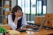 © Jirapong - Young woman engaged in online business with stress thoughtful within data products Sales did not meet target Selling products of This month