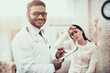 © Oleh Veres - Indian doctor seeing patients in office. Doctor is listening to woman's symptoms. Woman has high temperature.