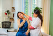 © StockImageFactory - Indian female doctor, physiotherapist diagnosing senior woman’s shoulder, neck  pain in posh clinic