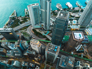 Aufkleber - An aerial panorama captures Hong Kong city's impressive skyscrapers and urban density.  Buildings tower over the landscape meeting the water's edge in this wide cityscape view.