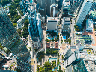 Poster - Aerial panorama of Hong Kong city reveals towering skyscrapers and urban landscape from a high vantage point. Dense buildings and streets stretch out in a wide view.