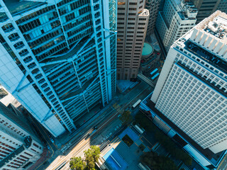 Poster - Aerial panorama of Hong Kong city showcases towering skyscrapers in a dense urban landscape. Roads and buildings dominate this high-angle view.