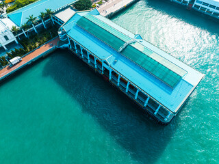 Aufkleber - Aerial panorama showcases Hong Kong city architecture with a building stretching into the turquoise water.  A scenic view of the urban landscape from above.