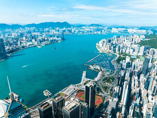 Aufkleber - An aerial panorama captures Hong Kong city's vibrant cityscape. Buildings meet the water in this wide view, showcasing the dense urban environment and distant mountains.