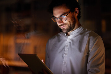Poster - Reading, night and business man on tablet for research project, online website and planning. Company, creative and person on digital tech working late for networking, report and proposal review