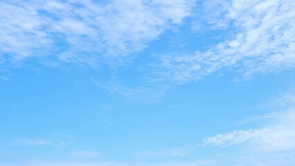 Wall Mural - A time-lapse of the sky, as light clouds wander across a brilliant blue backdrop, capturing the serene beauty of nature’s slow, peaceful passage through time.

