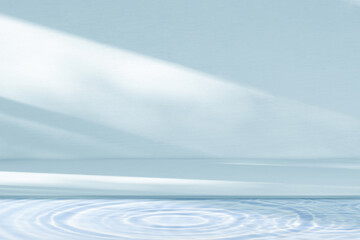 Poster - Water texture with light surface on blue wall background,Backdrop Summer nature sunlight,shadow reflection on podium display and water waves pattern for beauty,spa,cosmetic on summer product present