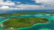 © AmazingAerialAgency - Aerial view of a tropical island with lush greenery and turquoise water, Western Province, Solomon Islands.