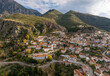 © AmazingAerialAgency - Aerial view of picturesque village nestled in serene mountains with charming houses and winding road, Dhermi, Vlore, Albania.