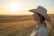 © ChaoticMind - Woman enjoying a golden sunset in a wide-open prairie setting with a straw hat and a calm expression