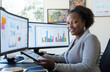 © Sehrish - Professional African American Woman Working on Tablet  Modern Office with Dual Monitors, Business Growth Charts & Creative Workspace  Natural Lighting, Marketing & Innovation Concept