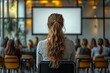 © otwdesign - A woman with long hair facing a presentation screen