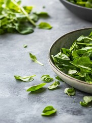 Poster - Fresh spinach leaves arranged elegantly in a bowl on a textured gray surface : Generative AI