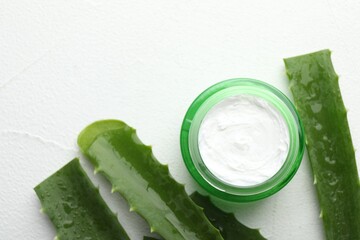 Wall Mural - cream and aloe leaves on white textured background, flat lay. space for text