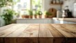 © DriftPixels - Rustic wooden table surface against a blurred modern kitchen backdrop with natural light and green plants creating a warm inviting ambiance