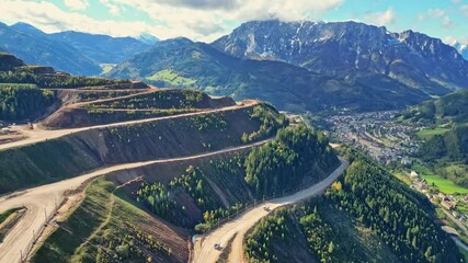 Aerial view of the industrial site of Erzberg iron mine surrounded by mountains and valleys, Eisenerz, Styria, Austria.