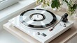 © Phurichai - Vintage turntable on wooden table with retro vinyl record and fresh flowers in bright, modern interior