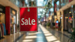 © syhin_stas - Hanging red sale sign in a fashion store, symbolizing seasonal discounts, retail promotions, and shopping trends in a bustling shopping mall.