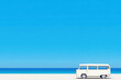 © jr-art - A white van is parked on a beach next to the ocean