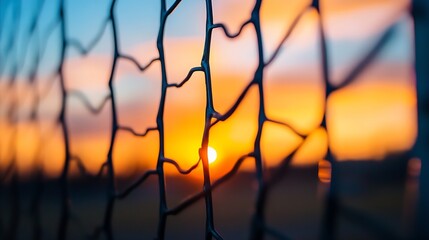 Fototapete - Colorful sunset seen through a sports net with a beautiful orange and blue sky backdrop : Generative AI
