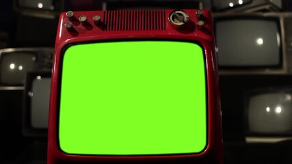 Wall Mural - close-up of a vintage red 1980s tv turning on with green screen using a modern remote - 4k