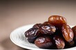 © Oualid - A close-up of dates fruit on a white plate