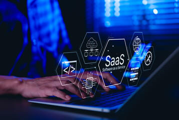 SaaS Software as a Service Concept. Man using laptop with futuristic interface SaaS (Software as a Service) icons, cloud computing, solutions, software development elements, modern technology platform
