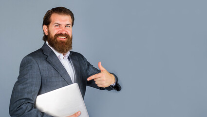 Businessman in formal wear pointing finger on laptop. Modern technology, internet, communication. Bearded man with with notebook. Copy space for advertising new website job search, ecommerce shopping.
