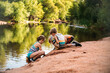 © Natalie Wheeler - Kids playing on side of lake