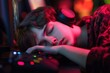 © Fatimah - Young Gamer Sleeping at the Computer in a Colorful Room