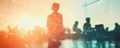 © sungedi - Silhouette of a businessperson standing before a collaborative team at work